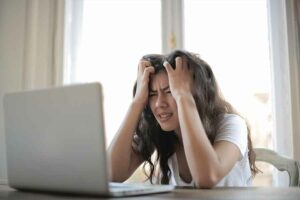 stressed student looking at computer