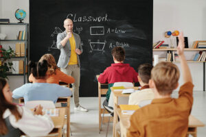 Teacher Teaching Photo by Max Fischer: https://www.pexels.com/photo/teacher-asking-a-question-to-the-class-5212345/